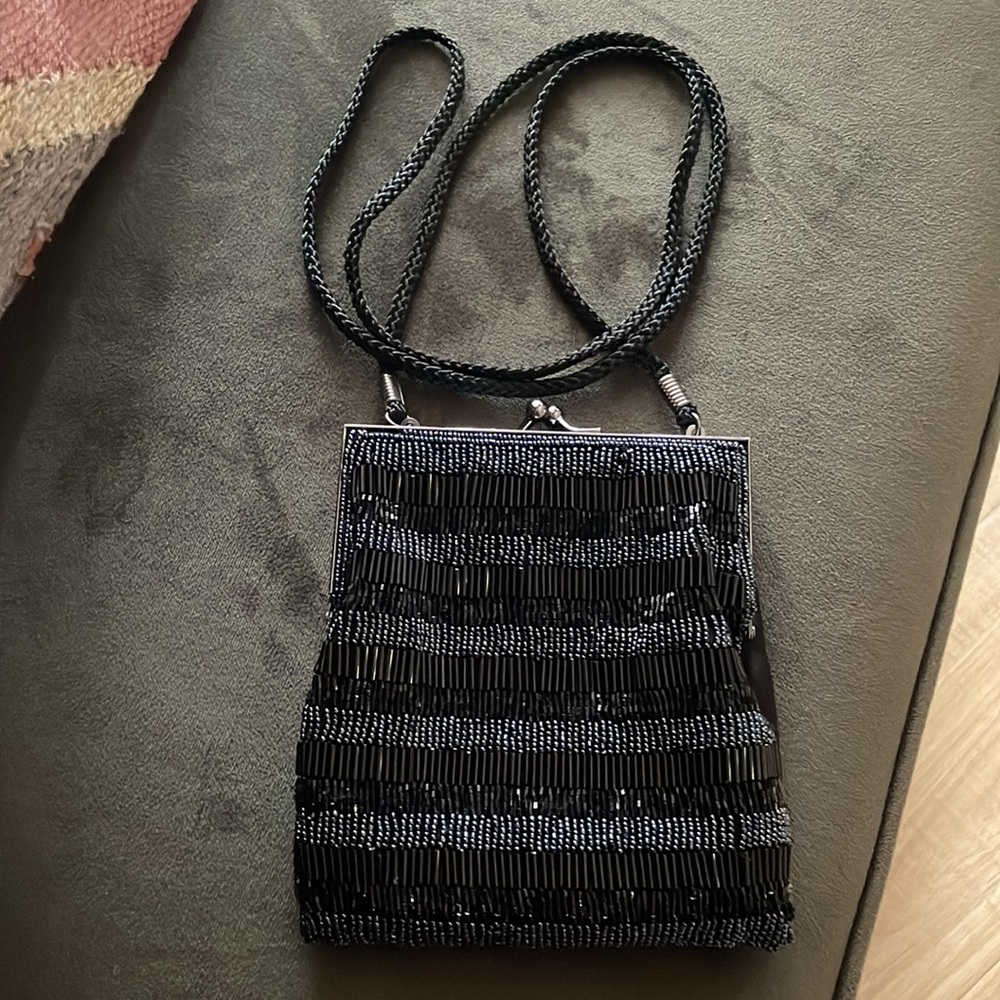 Lancome sequin mini purse with clasp closure, color black.